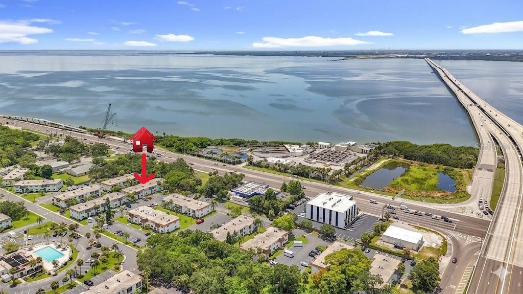 An aerial view shows a multi-family residential complex near a large body of water — 375 S MCMULLEN BOOTH ROAD UNIT 95, CLEARWATER, FL