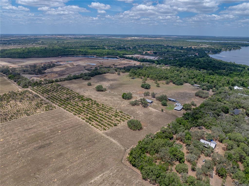 An aerial view shows a large rural property with fields, trees, and several small buildings — 10790 JIM EDWARDS ROAD, HAINES CITY, FL