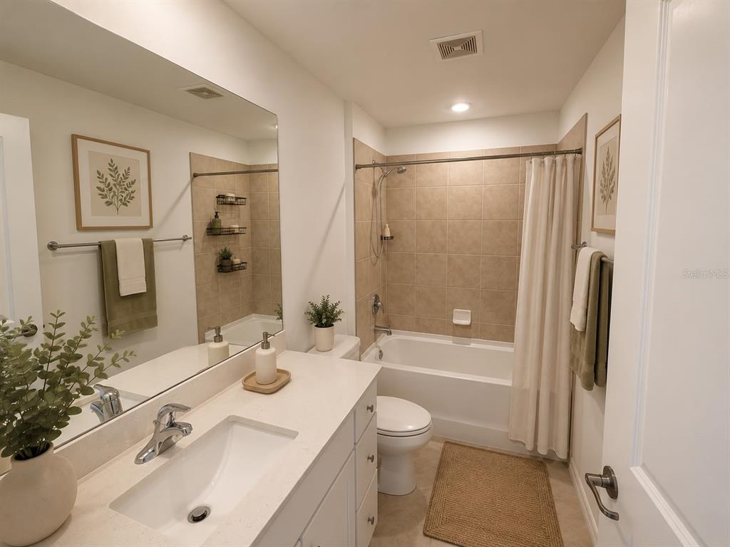 A bathroom features a white vanity, a toilet, and a bathtub with tan tile walls — 4104 NE 12TH COURT, CAPE CORAL, FL