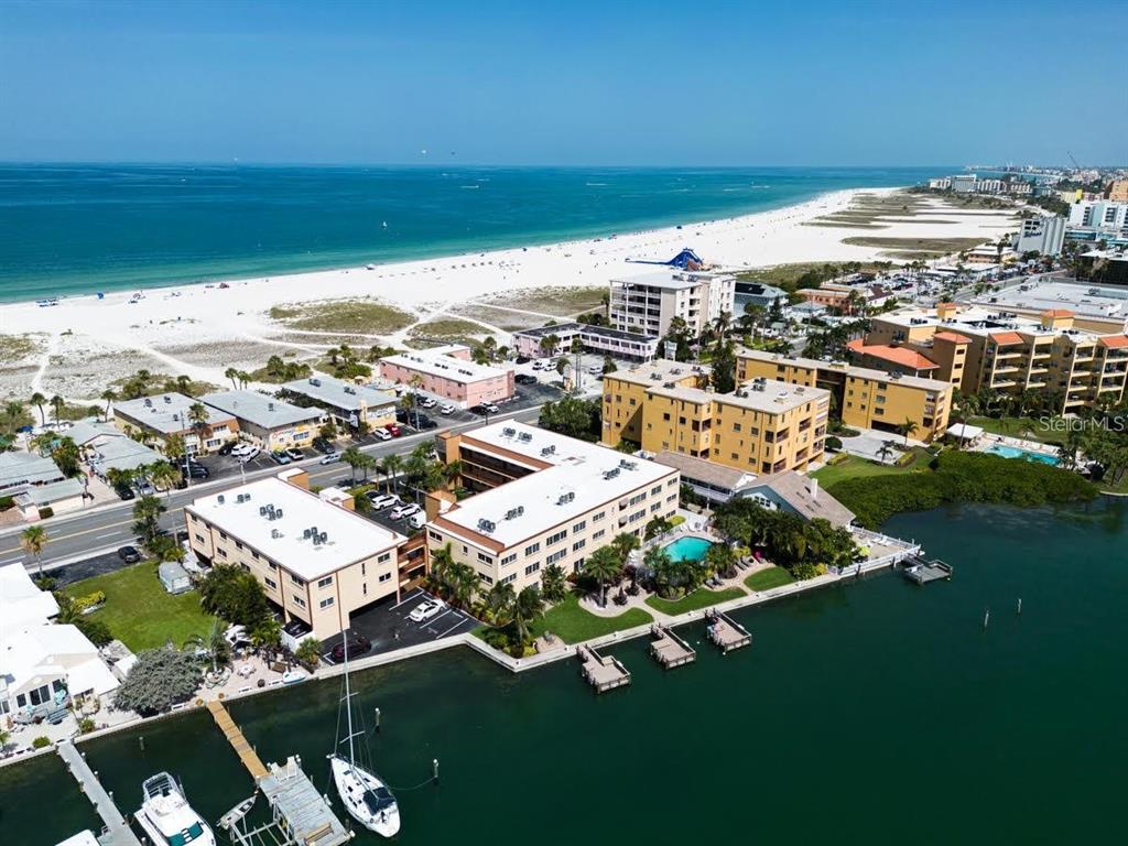 An aerial view of a waterfront apartment complex near a sandy beach and ocean — 10265 GULF BOULEVARD UNIT A308, ST PETERSBURG, FL
