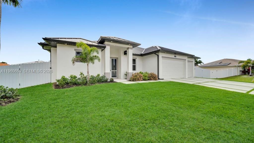 A modern single-story house features a white exterior, dark roof, and a paved driveway — 1726 SW 36TH TER,, Cape Coral FL 33914, CAPE CORAL, FL