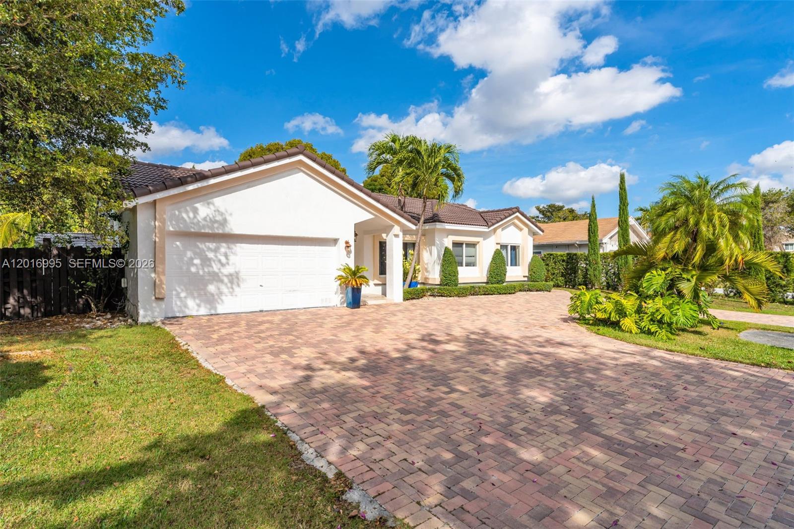 A single-story house with a white exterior, a tiled roof, and a large brick driveway — 15325 SW 54th Ter, Miami FL 33185, MIAMI, FL