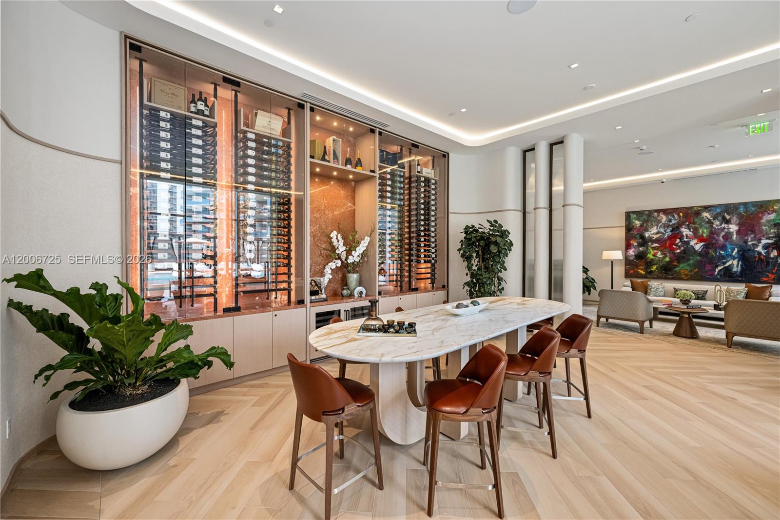 A modern lounge features a marble-topped table, leather bar stools, and a glass wine display — 77 SE 5 # 1505, Miami FL 33131, MIAMI, FL