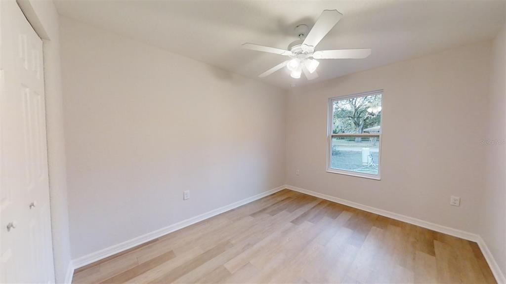 A single-story house with a tan exterior, white trim, and a one-car garage — 19656 SW LARK AVENUE, DUNNELLON, FL