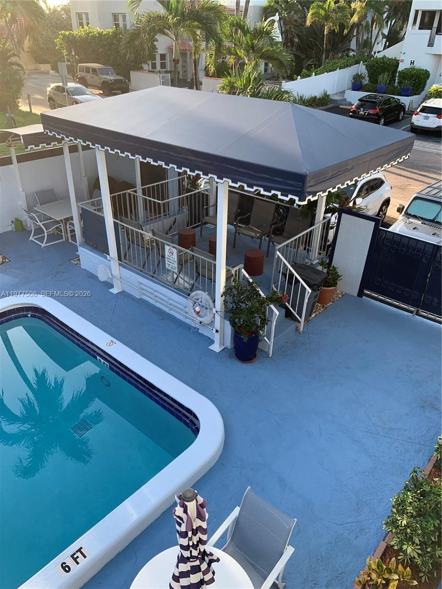 An elevated view shows a swimming pool next to a covered patio with outdoor seating — 322 Taylor St # 2D, Hollywood FL 33019, HOLLYWOOD, FL
