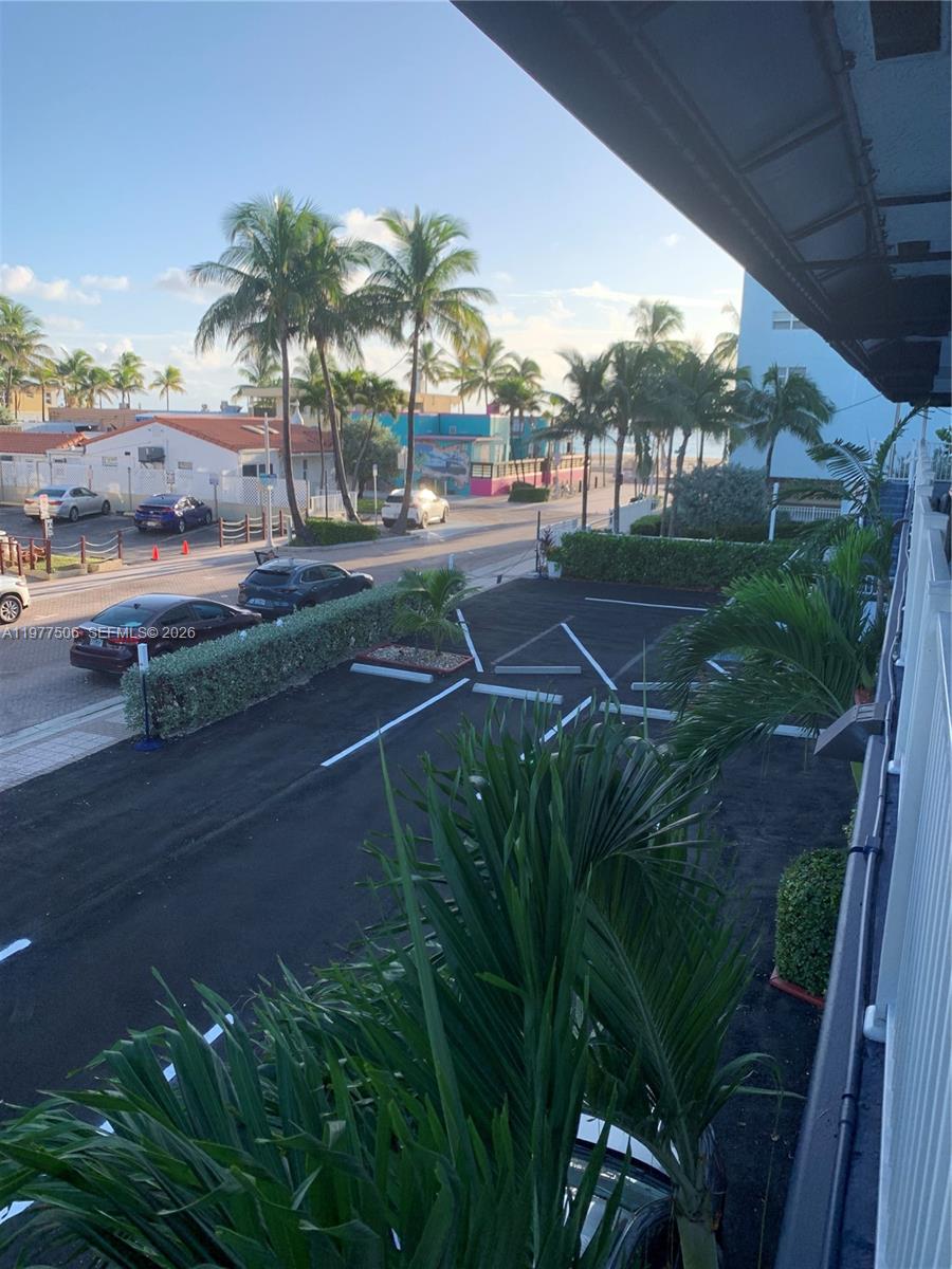 An elevated outdoor view shows a parking lot, palm trees, and a nearby street — 322 Taylor St # 2D, Hollywood FL 33019, HOLLYWOOD, FL