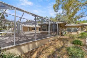 A screened-in patio area extends from the side of a single-story house — 4817 RIVERSIDE DRIVE, YANKEETOWN, FL