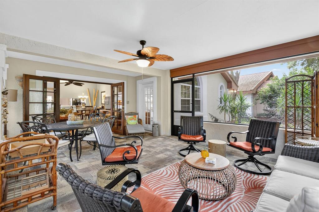 A covered patio features tile flooring, a ceiling fan, and outdoor furniture overlooking a yard — 29 SAN JOSE DRIVE, PALM COAST, FL