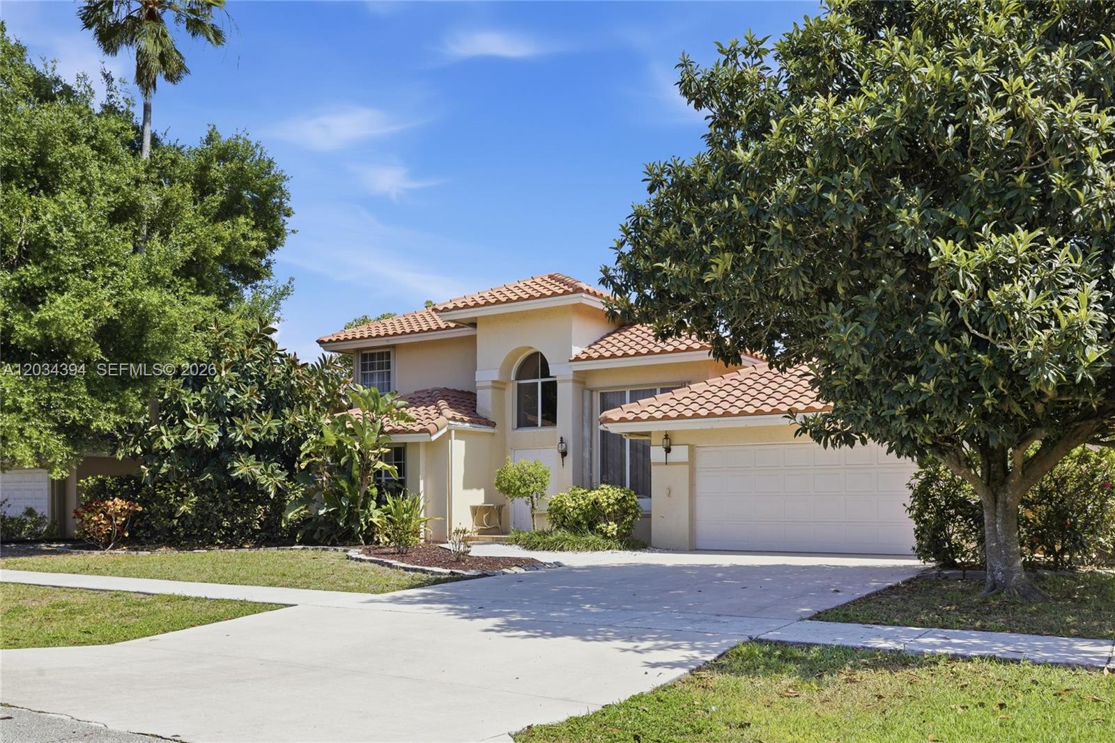 A two-story stucco house with a tile roof and a two-car garage — 9612 N Carousel Cir N, Boca Raton FL 33434, BOCA RATON, FL