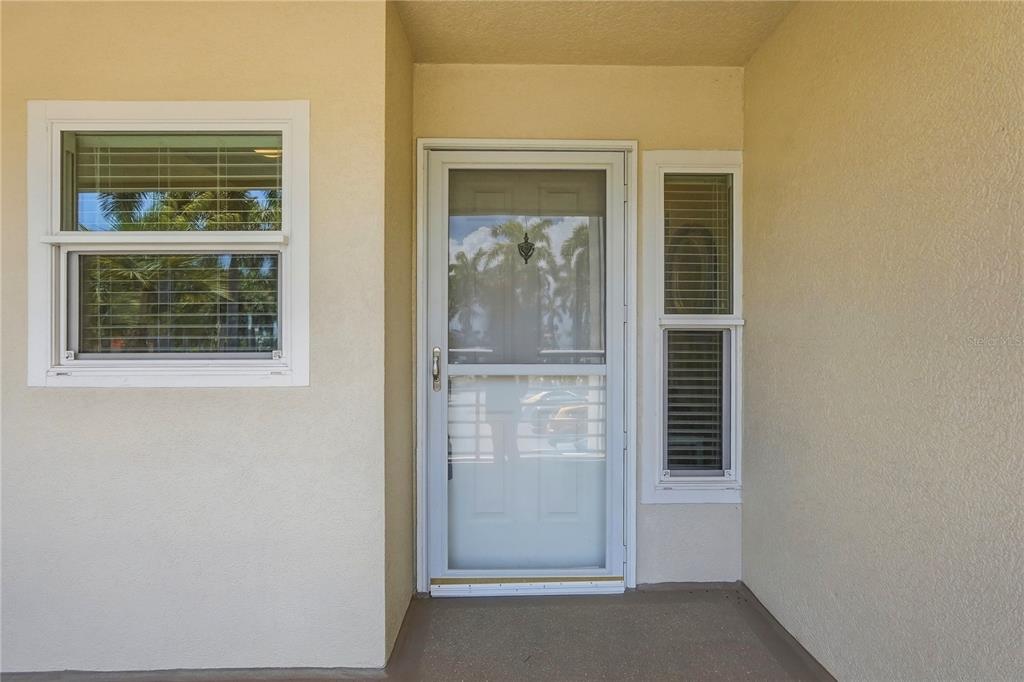 A front entryway features a white storm door, a side window, and a larger window — 6085 BAHIA DEL MAR CIRCLE UNIT 272, ST PETERSBURG, FL