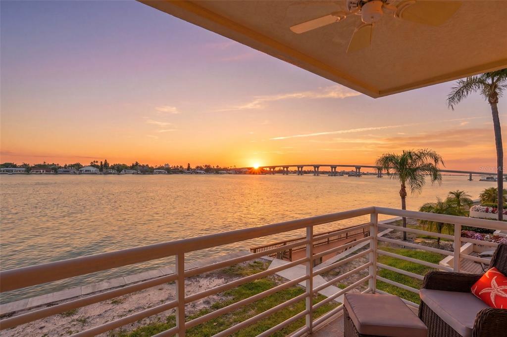 A balcony view overlooks a sunset over the water with a bridge in the distance — 6085 BAHIA DEL MAR CIRCLE UNIT 272, ST PETERSBURG, FL