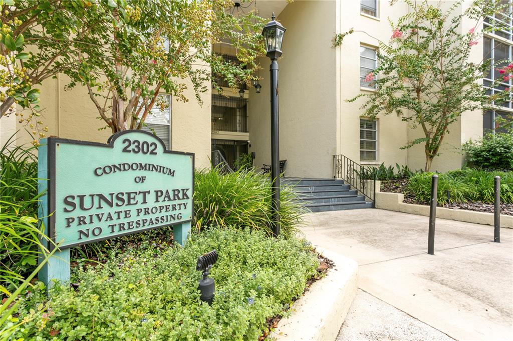A sign for the Condominium of Sunset Park stands before a multi-story residential building — 2302 S MANHATTAN AVENUE UNIT 111, TAMPA, FL