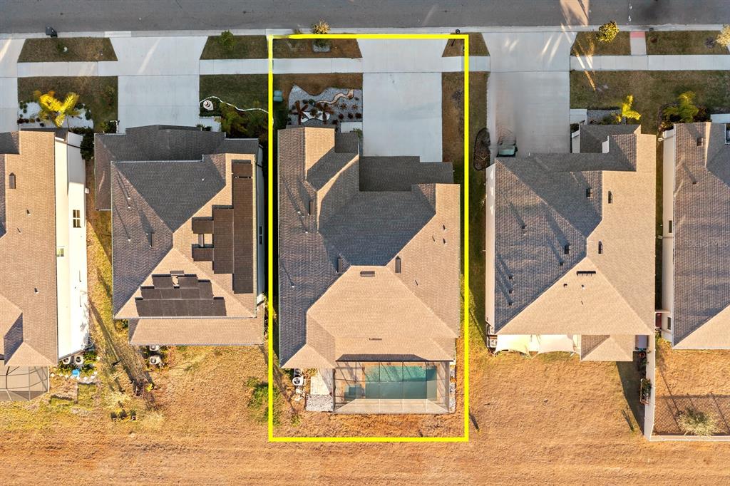 An aerial view shows a residential house with a screened-in pool and a concrete driveway — 13060 WILLOW GROVE DRIVE, RIVERVIEW, FL