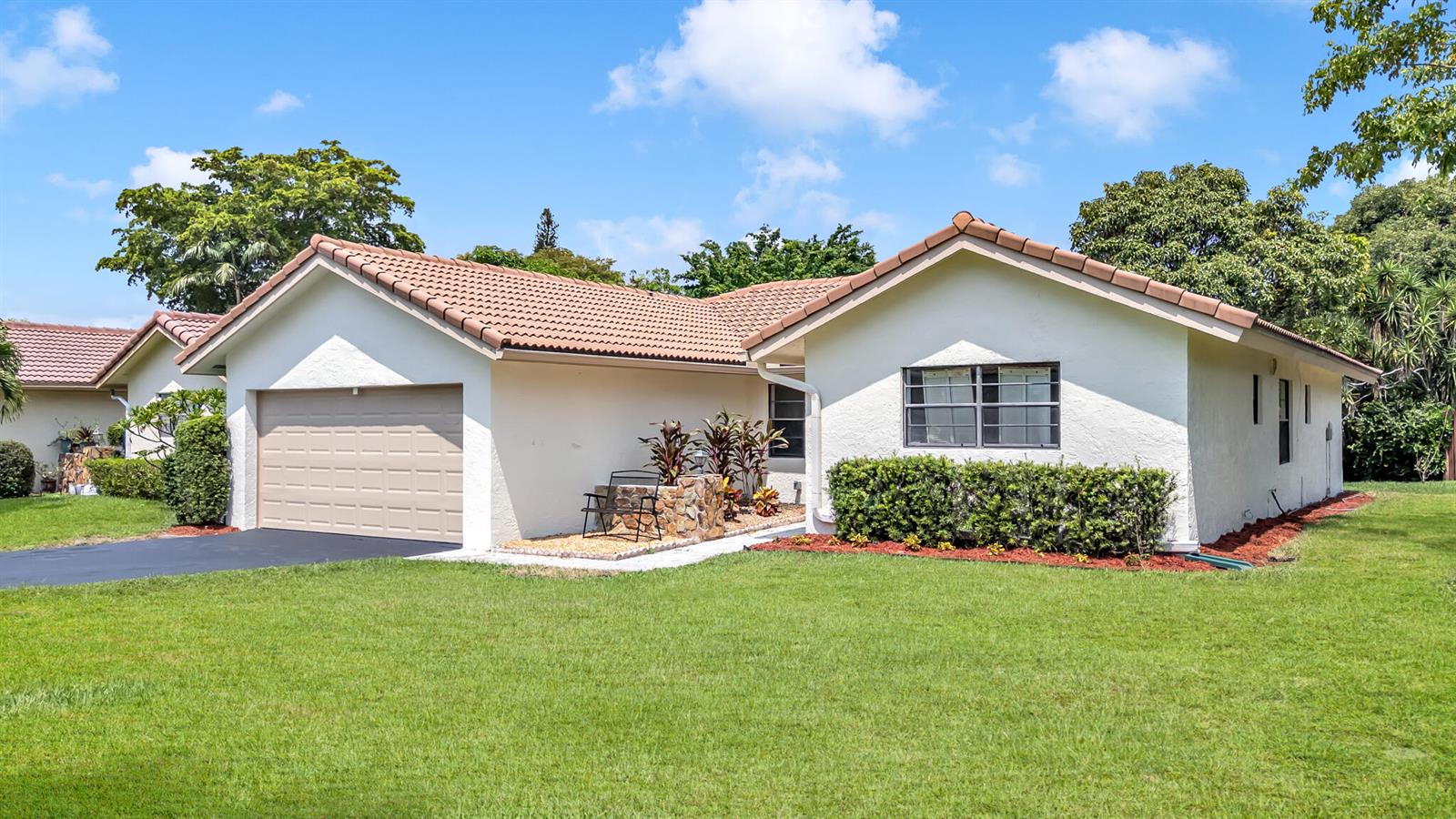 A single-story house with a tan garage, white stucco walls, and a tiled roof — 1273 Spring Circle Drive, Coral Springs FL 33071, CORAL SPRINGS, FL