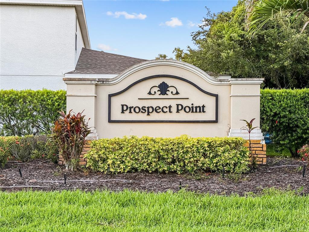 A beige monument sign with the text Prospect Point stands in front of landscaped bushes — 6116 35TH COURT E, BRADENTON, FL