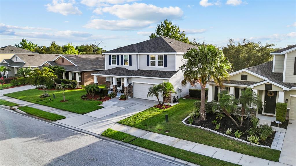 A two-story suburban house with a gray exterior, dark shutters, and a front-facing garage — 6116 35TH COURT E, BRADENTON, FL