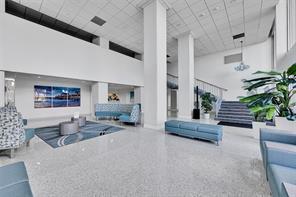 A spacious, modern hotel lobby with white walls, tiled floors, and blue seating areas — 405 N Ocean Boulevard # 1918, Pompano Beach FL 33062, POMPANO BEACH, FL