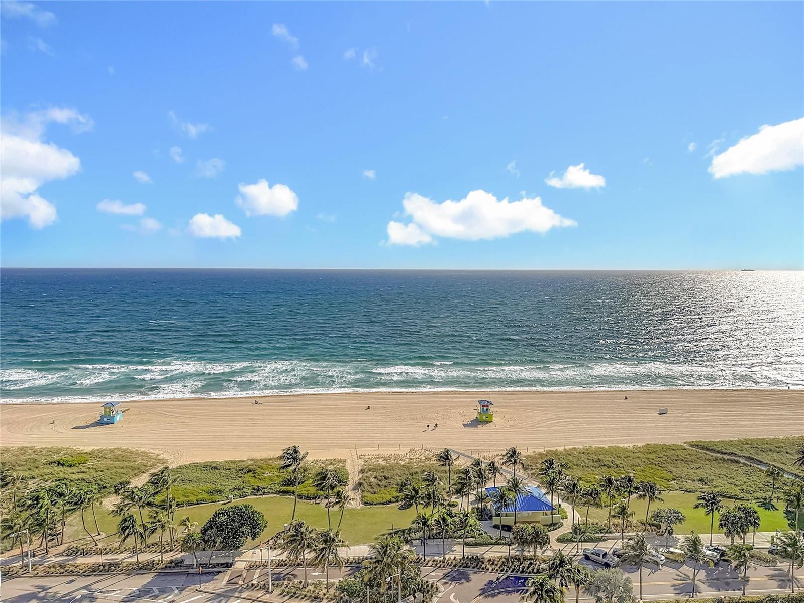 An aerial view of a sandy beach with two lifeguard stands and a coastal park — 405 N Ocean Boulevard # 1918, Pompano Beach FL 33062, POMPANO BEACH, FL