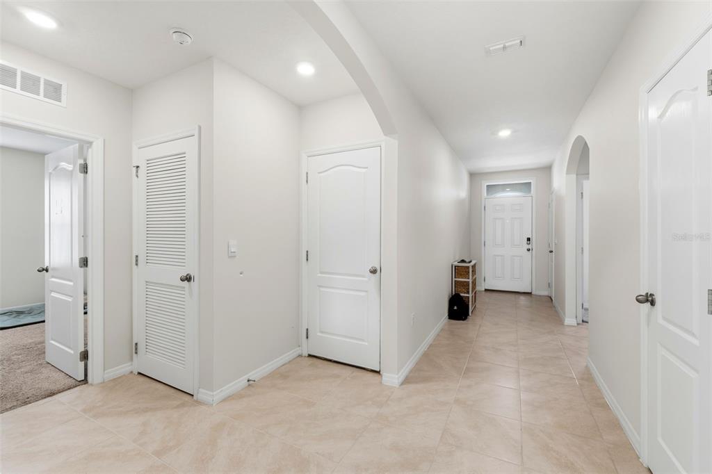 A bright entryway features light tile flooring, white walls, and several interior doors — 1349 SUGARWOOD STREET, DAVENPORT, FL