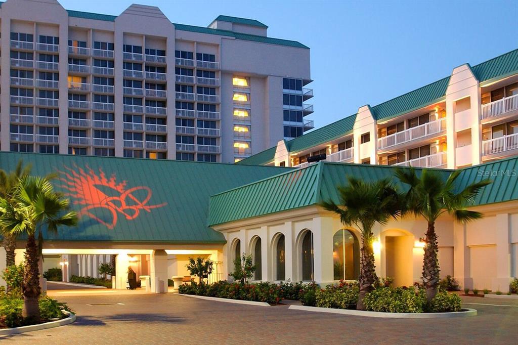 A multi-story resort building with a green metal roof and a paved driveway entrance — 2700 N ATLANTIC AVENUE UNIT 819, DAYTONA BEACH, FL