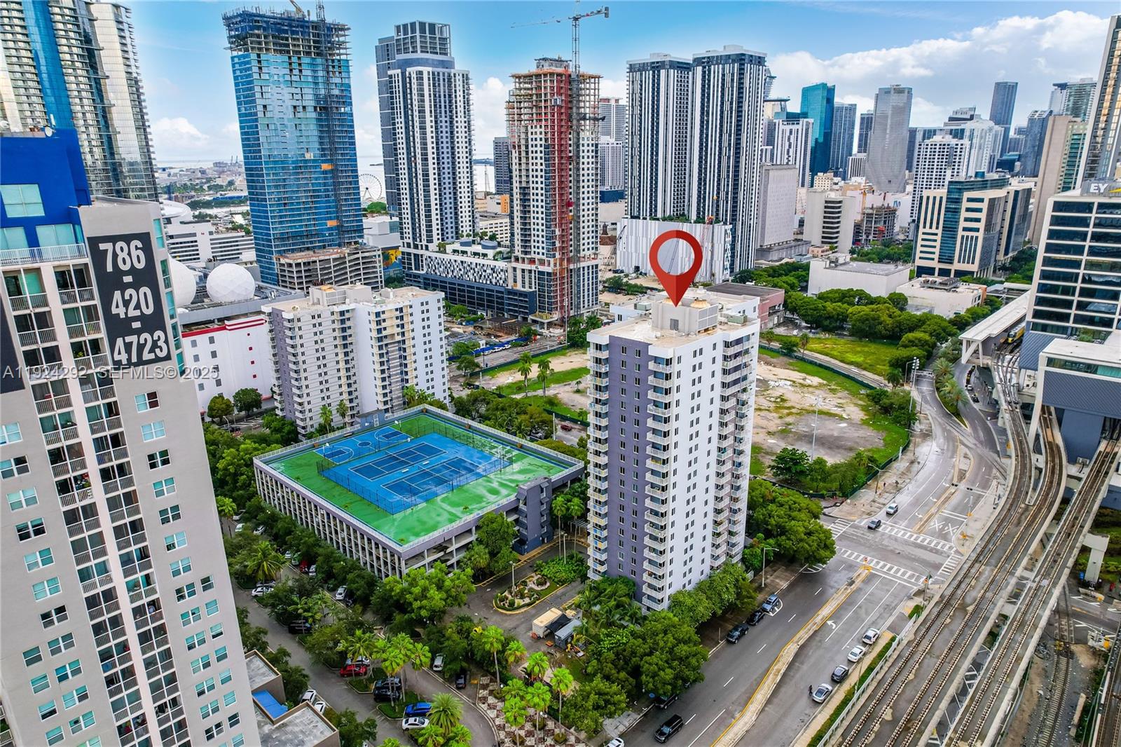 An aerial view shows a tall residential building marked with a red pin in Miami — 850 N Miami Ave # 408, Miami FL 33136, MIAMI, FL