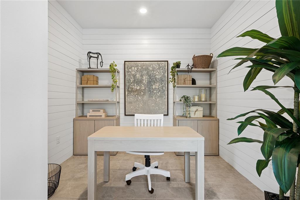A home office features a desk, two shelving units, and white shiplap walls — 4474 NW 37TH STREET ROAD, OCALA, FL