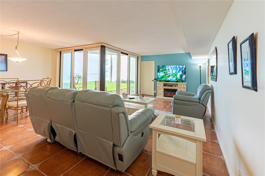 An aerial view shows a waterfront condominium complex with a swimming pool and parking lot — 5541 PUERTA DEL SOL BOULEVARD S UNIT 116, ST PETERSBURG, FL