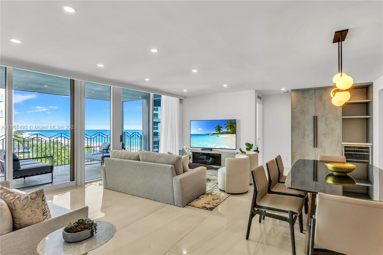 A modern living and dining area features tile floors, a balcony with ocean views, and furniture — 1500 Ocean Drive # 1003, Miami Beach FL 33139, MIAMI BEACH, FL