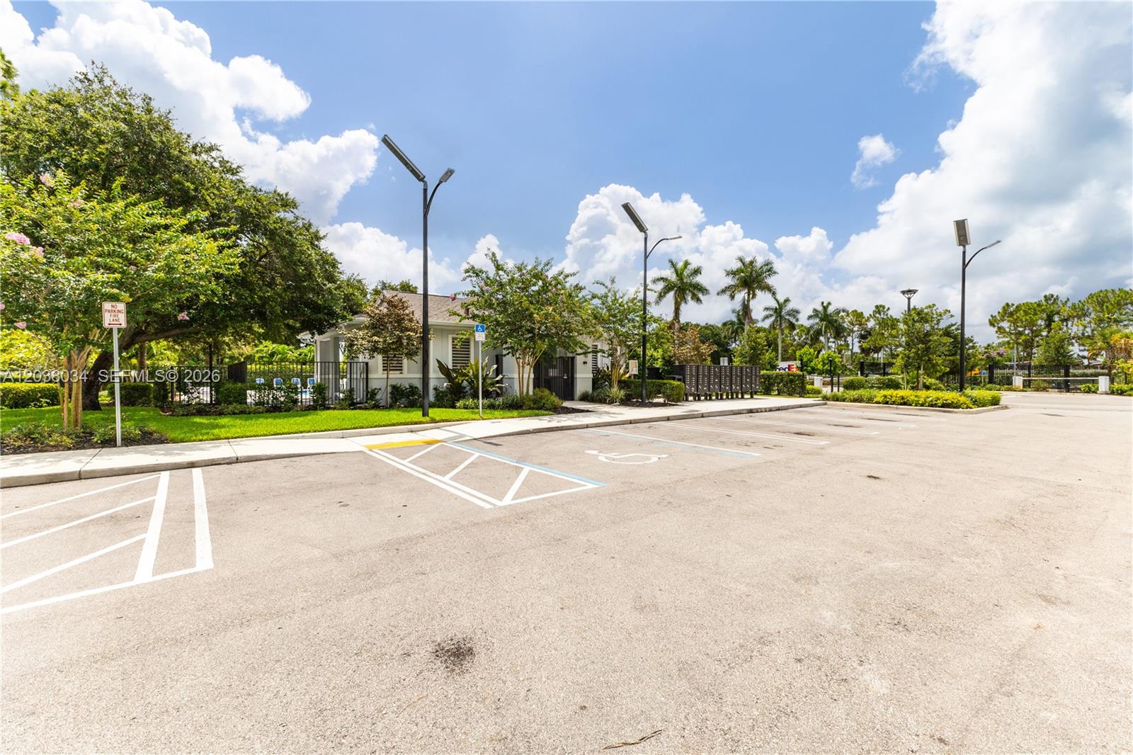 An outdoor parking lot features a handicap-accessible space and a small building with landscaping — 5319 Flannigan Way # 0, Lake Worth FL 33463, LAKE WORTH, FL