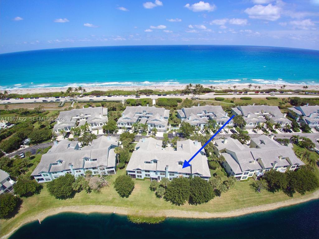 An aerial view of a multi-story residential complex situated near a beach and lake — 905 Mainsail Circle # 905, Jupiter FL 33477, JUPITER, FL