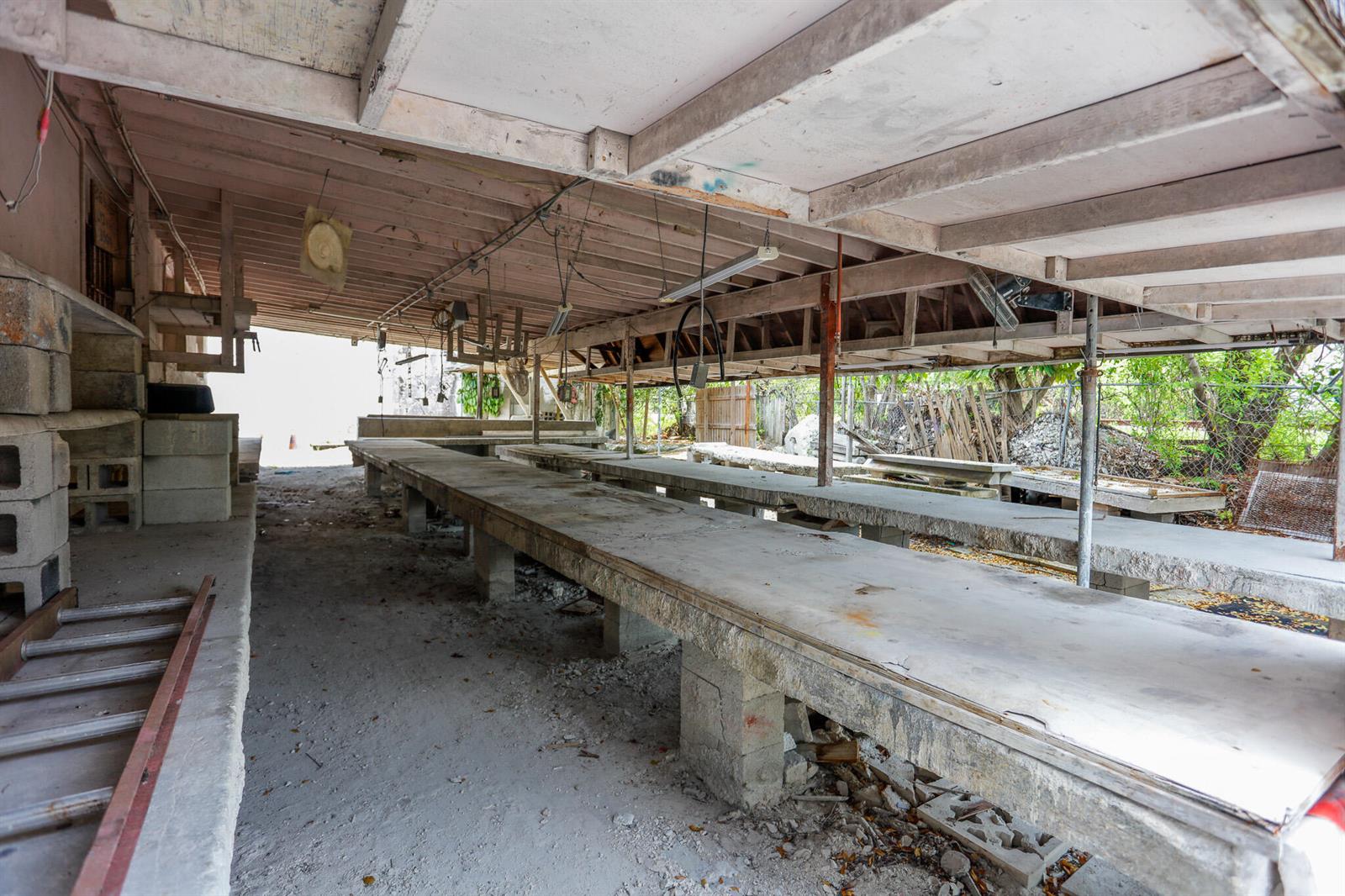 An open-air, covered structure features long concrete work tables supported by cinder block pillars — 1620 S Dixie Highway, Pompano Beach FL 33060, POMPANO BEACH, FL