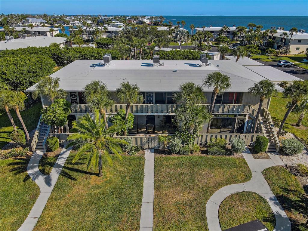 An aerial view of a two-story apartment building with a flat roof and palm trees — 6400 FLOTILLA DRIVE UNIT 15, HOLMES BEACH, FL