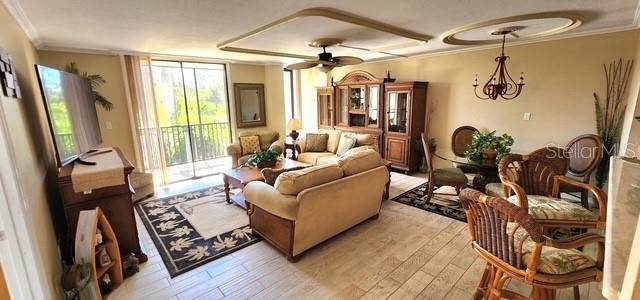 A living and dining area features tile floors, a ceiling fan, and a sliding glass door — 25188 MARION AVENUE UNIT D104, PUNTA GORDA, FL