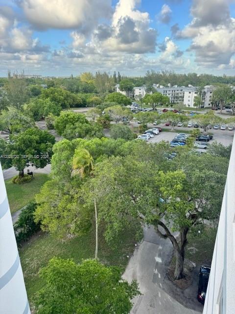 An elevated view shows a parking lot surrounded by trees and residential buildings — 3301 Spanish Moss Ter # 803, Lauderhill FL 33319, LAUDERHILL, FL