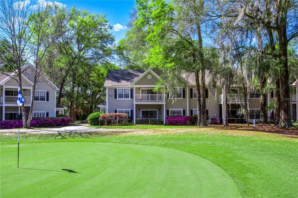 A view of a golf course green in front of multi-story apartment buildings with balconies — 10000 SW 52ND AVENUE UNIT 124, GAINESVILLE, FL