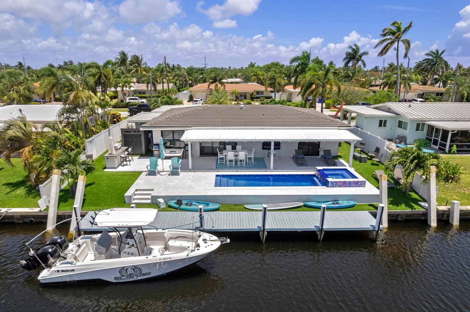 An aerial view of a waterfront home featuring a pool, spa, patio, and private dock — 160 SE 12th Court, Pompano Beach FL 33060, POMPANO BEACH, FL