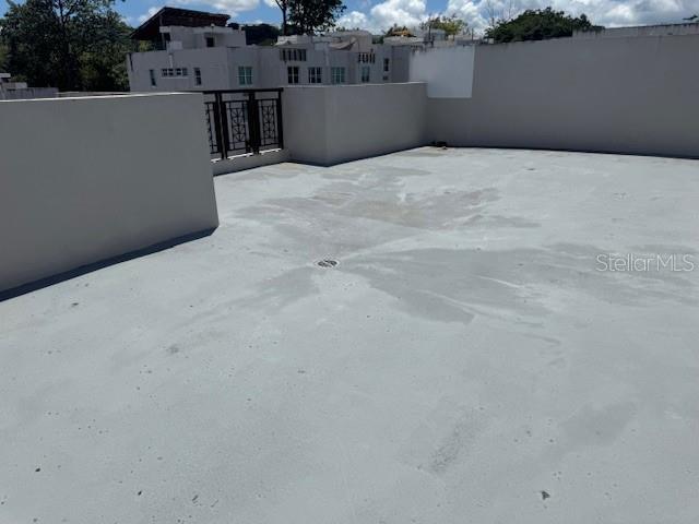 A flat, gray concrete rooftop terrace features a central drain and low perimeter walls — Ave. 50 A COND. QUINTA BALDWIN UNIT 1108, BAYAMON, PR