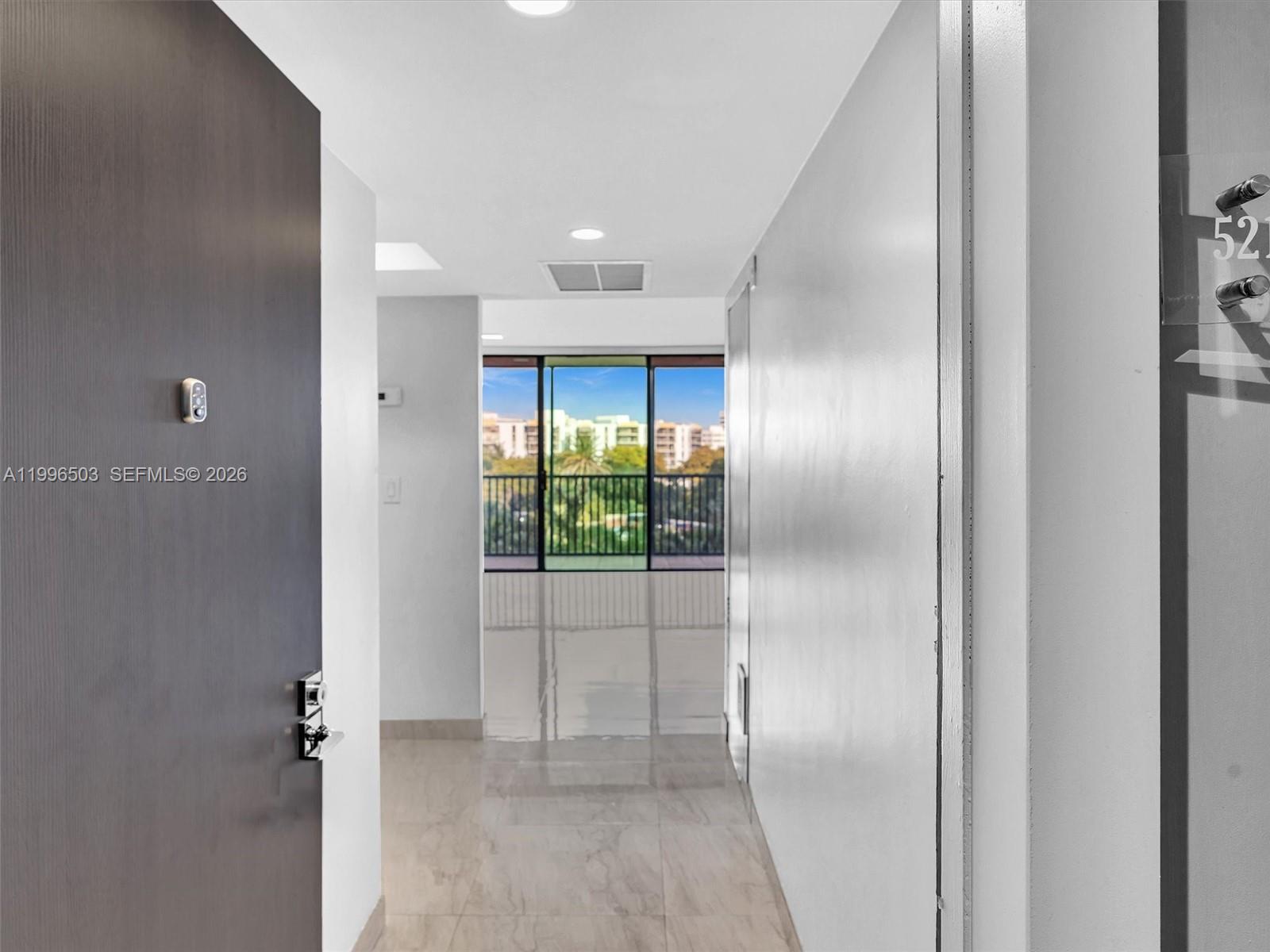 Bright entry leading into living area — AVENTURA, FL