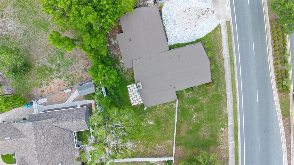 An aerial view shows a house with a dark roof, a patio, and a fenced yard — 1511 E HORATIO AVENUE, MAITLAND, FL