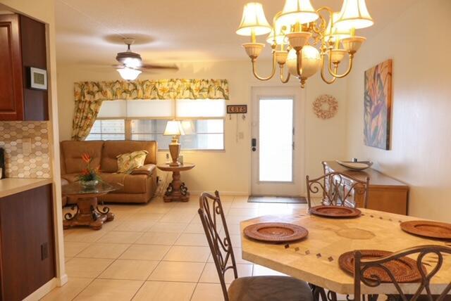 A dining area with a chandelier and a living room with a sofa and ceiling fan — 1011 Cornwall A # 1011, Boca Raton FL 33434, BOCA RATON, FL