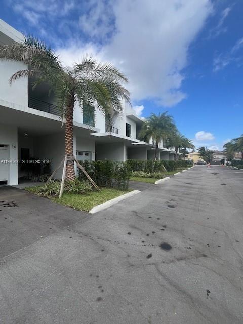 A row of modern white townhouses with palm trees and a paved driveway — 2526 Pierce St # 12, Hollywood FL 33020, HOLLYWOOD, FL