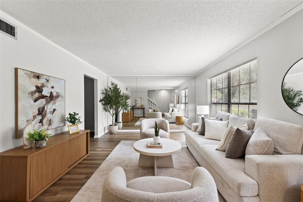 A living room features light wood floors, a beige sofa, and a large mirrored wall — 14809 WINDING CREEK COURT, TAMPA, FL