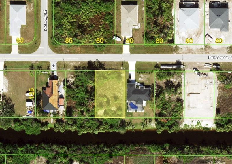 This aerial map shows a vacant residential lot highlighted in yellow between two existing houses — 12155 FORESMAN BOULEVARD, PORT CHARLOTTE, FL