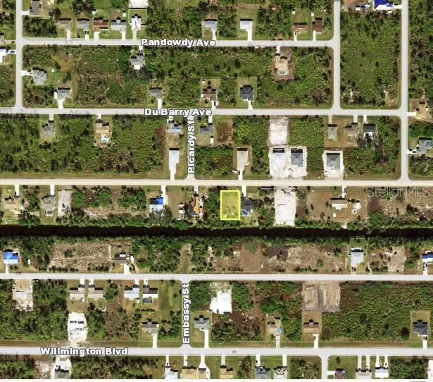 This is an aerial map view showing a vacant residential lot highlighted in yellow — 12155 FORESMAN BOULEVARD, PORT CHARLOTTE, FL