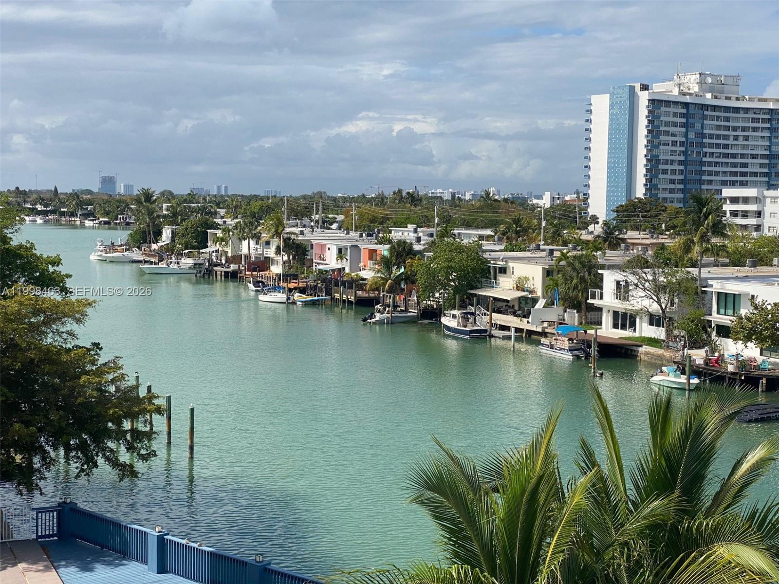 An elevated view of a canal lined with houses, private docks, and docked boats — 7125 Bay Dr # 506, Miami Beach FL 33141, MIAMI BEACH, FL