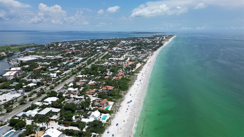 An aerial view of a coastal neighborhood featuring houses along a white sand beach — 15480 ARIBE AVENUE, PORT CHARLOTTE, FL