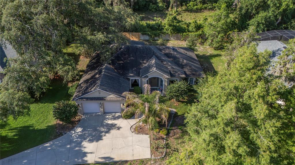 An aerial view of a single-story house with a two-car garage and a concrete driveway — 177 OVEROAKS PLACE, SANFORD, FL