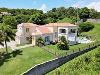 An aerial view of a two-story house with a swimming pool and a grassy yard — 53 HARBOUR LIGHTS, HUMACAO, PR