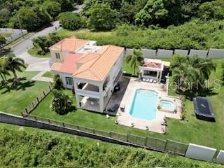 An aerial view shows a two-story house with a tiled roof, pool, and detached gazebo — 53 HARBOUR LIGHTS, HUMACAO, PR