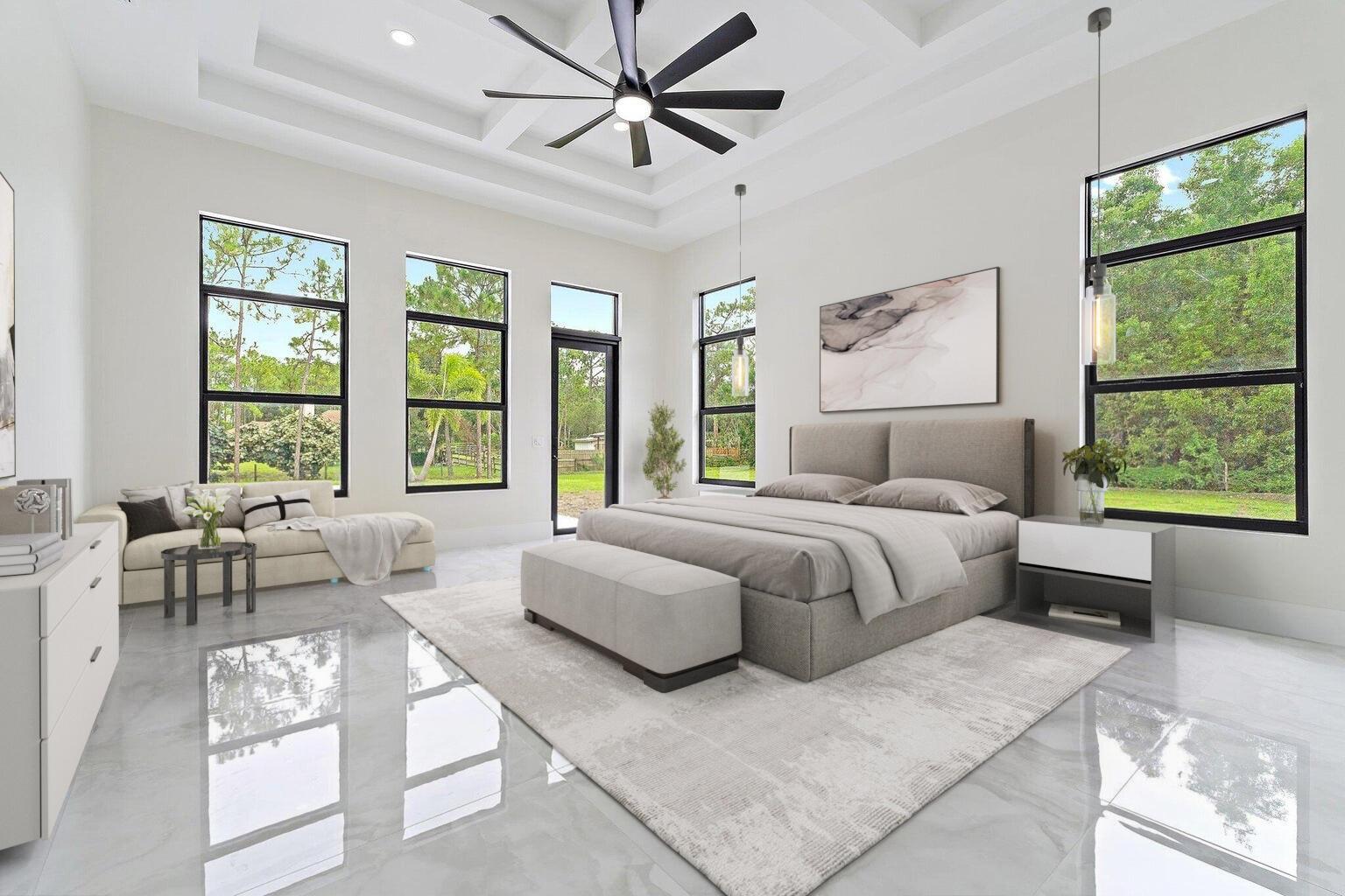 A modern bedroom features a tray ceiling, large windows, gray tile floors, and neutral furniture — 12850 152nd Street N, Jupiter FL 33478, JUPITER, FL